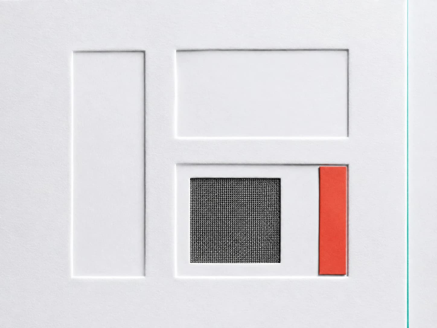 Embossed white sample compartments with a graphite mesh insert and coral selection tab